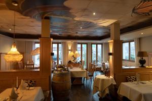 a restaurant with tables and chairs and a ceiling at Hotel & Restaurant Bestenheider Stuben in Wertheim