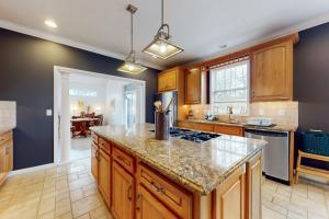 a kitchen with wooden cabinets and a counter top at Pine Crest in Pocono Pines