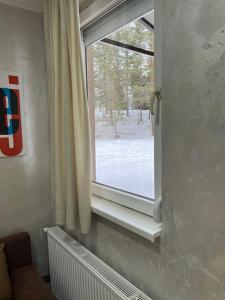 a window with a view of a snow covered yard at Apartmani Vrabac 4 in Divčibare