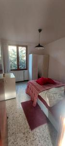 a bedroom with a bed with a red blanket on it at Villa Maison de campagne 04 Vacheres Luberon 3 chambres 8 personnes in Vachères