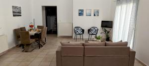 a living room with a couch and a table at SunShine House in Ermoupoli