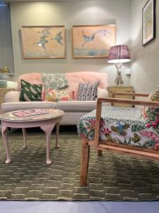 a living room with a couch and a table at Rowan Cottage in Cromford