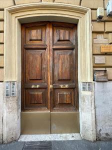 a large wooden door on the side of a building at Scipioni Vatican Suite in Rome