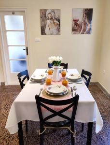 a table with a white table cloth and flowers on it at Silvermoon Apartment in Kostrena