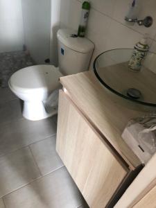 a bathroom with a toilet and a sink at Casa Lucy in Ibagué