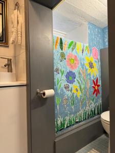 baño con un mural de flores en la pared en California guest house, en Greenwich