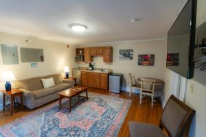 a living room with a couch and a kitchen at The Escape in Lewisburg