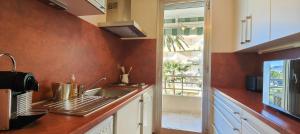 a kitchen with a sink and a counter top at 50 m cocoon of Love with a common shared pool in Saint-Raphaël