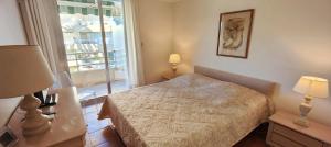 a small bedroom with a bed and a window at 50 m cocoon of Love with a common shared pool in Saint-Raphaël