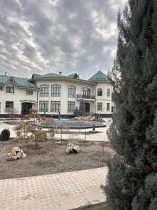 a large white building with a lot of windows at EMIRS GARDEN Residence in Bukhara