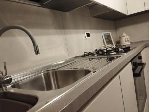 a kitchen with a sink and a stove at House Lido in Gallipoli