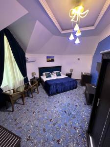 a large bedroom with a bed and a ceiling at EMIRS GARDEN Residence in Bukhara