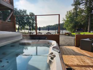 a bath tub sitting on top of a wooden deck at Auberge Morritt in Mont-Tremblant