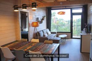 a living room with a table and a couch at NidoGredos Cabañas Ecológicas de Diseño in El Tiemblo