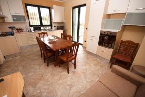 a kitchen with a table and chairs and a couch at La Casa di Ninna Affittacamere in Ariano Irpino