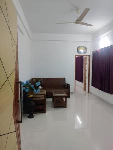 a living room with a couch and a table at Spacious 2BHK Near Airport in Cochin