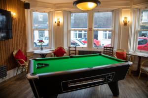a pool table in a room with windows at The Fig Tree Markinch, Glenrothes in Markinch