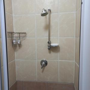 a shower with a shower head in a bathroom at Cronin Luxury Accomodation Room 3 in Kimberley