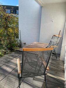 a chair and a table on a porch at Dünenrose 21 in Norderney
