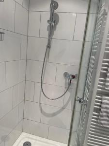 a shower with a shower head in a bathroom at Dünenrose 21 in Norderney