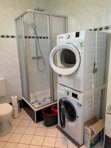 a bathroom with a shower and a washer and dryer at Hochstrasse 10 in Unna