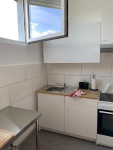 a white kitchen with a sink and a window at Hochstrasse 10 in Unna