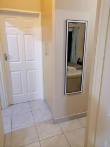a room with a door and a mirror on the wall at Peaceful Home with Sbo in Pietermaritzburg