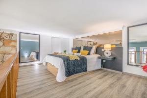 a white bedroom with a large bed and windows at Deluxe Spacious Flats w Mezzanine by Host Wise in Porto