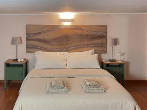 a bedroom with a large bed with two night stands at Etna Home in Catania