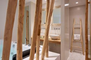 a kitchen with wooden beams and a counter with a sink at Nirome Luxury Suites in Adamantas