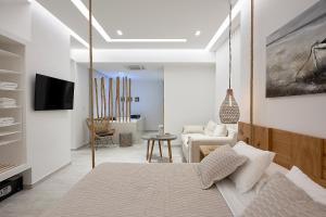 a living room with a hanging bed and a couch at Nirome Luxury Suites in Adamantas