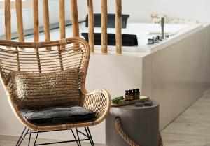 a rattan chair in a kitchen with a counter at Nirome Luxury Suites in Adamantas