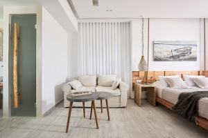 a living room with a couch and a table at Nirome Luxury Suites in Adamantas