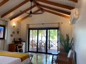 a bedroom with a bed and a view of a patio at Coconut Row Boutique Hotel in Hopkins