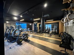 a gym with several treadmills and cardio machines at Industrial Vistula Apartment Free Parking in Kraków
