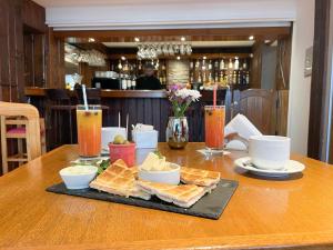 a table with a tray of bread and drinks on it at Hotel Nahuel Huapi in San Carlos de Bariloche