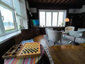 uma sala de estar com um tabuleiro de xadrez e uma televisão em Exceptionnel-Spacieux-Vue mer Hendaye plage-Garage em Hendaye