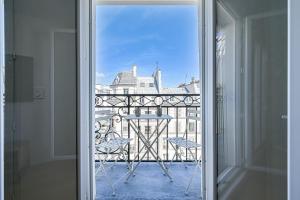 a view from a door of a balcony with chairs at Terrasse au coeur du Marais in Paris