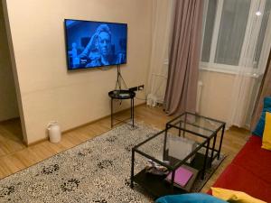sala de estar con TV de pantalla plana en la pared en Cosy apartment near downtown and airport en Vilna