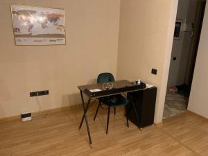 a desk and a chair in a room at Cosy apartment near downtown and airport in Vilnius