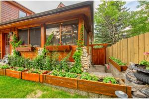 a house with a garden in front of it at B&B on Mountain Lane - Private Suite & Hot Tub in Banff