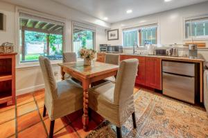 a kitchen with a wooden table and chairs at B&B on Mountain Lane - Private Suite & Hot Tub in Banff