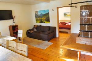 a living room with a couch and a bed at Jacobs 4 Bedroom Private House in Kranjska Gora