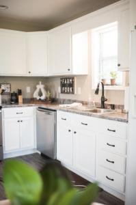 a kitchen with white cabinets and a sink at Nordins Hidden Hillside Cabin in Dardanelle