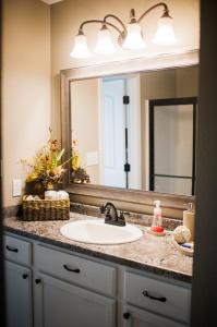 a bathroom counter with a sink and a mirror at Nordins Hidden Hillside Cabin in Dardanelle