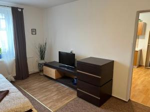 a living room with a tv and a dresser at Ubytování Rozsochy in Rozsochy