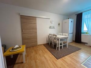 a living room with a table and a refrigerator at Ubytování Rozsochy in Rozsochy