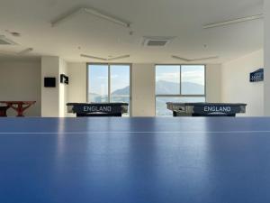 a blue ping pong table in a room with windows at El Samario Cumbia Host-Playa Salguero- Santa Marta in Gaira