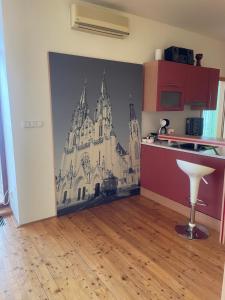 a kitchen with a wall mural of a castle at Apartmán u Dómu in Olomouc