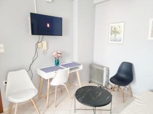 a room with a desk and chairs and a tv at inspire tripoli in Tripolis